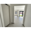 original_1791188457_minimalist-hallway-to-sunlit-living-area.png