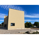 original_1792006971_modern-beige-stucco-building-under-streaked-skies.png