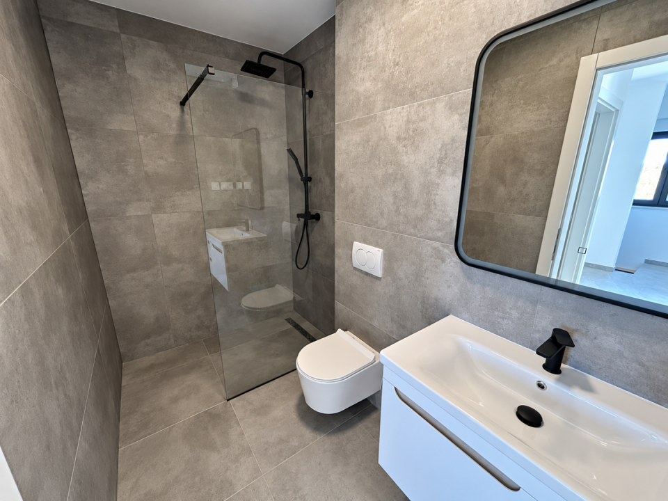 original_1790938587_modern-gray-tile-bathroom-with-black-fixtures.png