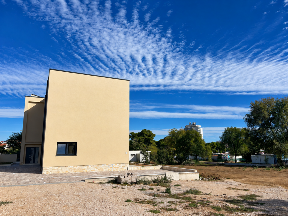 original_1792007193_modern-house-under-a-rippling-blue-sky.png